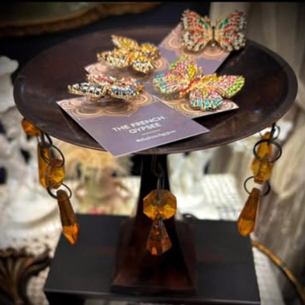 Jeweled butterfly brooches on a vintage stand